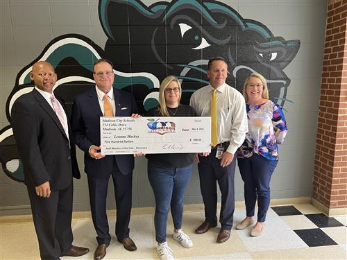 Leeanne Mackey with oversized check and prize patrol